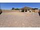 Spacious backyard featuring a covered patio and gravel landscaping at 13037 W Laurel Ln, El Mirage, AZ 85335