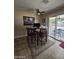 Dining table area with a ceiling fan and patio access at 13037 W Laurel Ln, El Mirage, AZ 85335