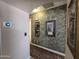 Hallway with decorative wall finish and art leading into other rooms at 13037 W Laurel Ln, El Mirage, AZ 85335