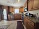 Well-equipped kitchen featuring stainless steel appliances, granite countertops, and custom wood cabinets at 13037 W Laurel Ln, El Mirage, AZ 85335