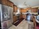 Well-equipped kitchen with stainless steel appliances, granite countertops, and custom wood cabinets at 13037 W Laurel Ln, El Mirage, AZ 85335