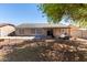Fully fenced backyard featuring a patio, low maintenance landscaping, and shade tree at 1376 E Rosemary Trl, Casa Grande, AZ 85122