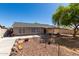 Backyard featuring low maintenance landscaping, patio, and a fire pit at 1376 E Rosemary Trl, Casa Grande, AZ 85122
