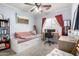 Bedroom featuring a day bed, desk, bookshelves, neutral carpet, and natural light from a window at 1376 E Rosemary Trl, Casa Grande, AZ 85122