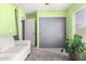 Light green bedroom with a closet, seating, carpet, and a monstera plant near the window at 1376 E Rosemary Trl, Casa Grande, AZ 85122