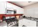 Well-organized kitchen featuring white cabinets, stainless steel appliances, and functional layout at 1376 E Rosemary Trl, Casa Grande, AZ 85122