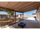 Covered patio and spacious backyard featuring mature tree, desert landscaping and block fencing at 1376 E Rosemary Trl, Casa Grande, AZ 85122