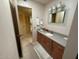 Bathroom featuring a vanity with wooden cabinets, neutral countertops, and large mirror at 13857 N 108Th Dr, Sun City, AZ 85351