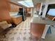 Well-lit kitchen featuring wood cabinets, modern appliances, and a breakfast bar at 13857 N 108Th Dr, Sun City, AZ 85351