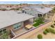 Aerial view of a home with a well maintained backyard with a hot tub and manicured landscaping at 14075 W Desert Flower Dr, Goodyear, AZ 85395