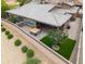 Aerial view of a home with a well maintained backyard featuring a hot tub and artificial turf at 14075 W Desert Flower Dr, Goodyear, AZ 85395