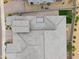 Aerial view of a tiled roof over a home with a manicured backyard that has green turf and rock landscaping at 14075 W Desert Flower Dr, Goodyear, AZ 85395