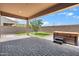 Pavered backyard featuring an outdoor space with a hot tub, gravel and artificial grass at 14075 W Desert Flower Dr, Goodyear, AZ 85395