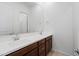 Bathroom vanity with double sinks, dark wood cabinets, and a large mirror at 14075 W Desert Flower Dr, Goodyear, AZ 85395