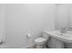 Powder room with a toilet, mirror and pedestal sink at 14075 W Desert Flower Dr, Goodyear, AZ 85395