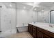 Bathroom featuring a glass shower, soaking tub, double sink vanity, and tile floors at 14075 W Desert Flower Dr, Goodyear, AZ 85395