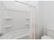 Bright bathroom with a shower and tub combination featuring a decorative shower curtain at 14075 W Desert Flower Dr, Goodyear, AZ 85395