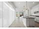 Bright kitchen with a large island, granite countertops and stainless steel appliances, open to backyard at 14075 W Desert Flower Dr, Goodyear, AZ 85395