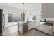 Open concept kitchen featuring granite countertops, stainless steel appliances and access to backyard at 14075 W Desert Flower Dr, Goodyear, AZ 85395