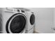 Laundry room with a front loading washer and dryer with UltraFresh Vent System at 14075 W Desert Flower Dr, Goodyear, AZ 85395