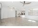 Open-concept living room showcasing tile floors, modern lighting, and seamless kitchen integration at 14075 W Desert Flower Dr, Goodyear, AZ 85395