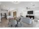 Open-concept living room with modern lighting, dining area, and access to the backyard at 14075 W Desert Flower Dr, Goodyear, AZ 85395