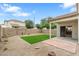 Private backyard features brick-paved patio and synthetic grass lawn at 1410 S Boulder St # A, Gilbert, AZ 85296