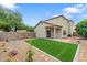 Private backyard features brick-paved patio and synthetic grass lawn at 1410 S Boulder St # A, Gilbert, AZ 85296