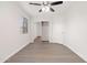 Bright bedroom features wood-look flooring, closet, ceiling fan, and fresh white paint at 1410 S Boulder St # A, Gilbert, AZ 85296
