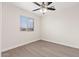 Bedroom featuring wood-look flooring, a window with blinds, and fresh white paint at 1410 S Boulder St # A, Gilbert, AZ 85296