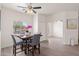 Bright dining area featuring wood-look tile floors, modern ceiling fan, and an elegant dining set at 1410 S Boulder St # A, Gilbert, AZ 85296