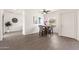 Bright dining area featuring wood-look tile floors, modern ceiling fan, and an elegant dining set at 1410 S Boulder St # A, Gilbert, AZ 85296