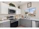 Modern kitchen featuring stainless steel appliances, white countertops and grey cabinets at 1410 S Boulder St # A, Gilbert, AZ 85296