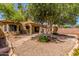 Backyard featuring desert landscaping, a covered patio, and gravel at 14561 W Winding Trl, Surprise, AZ 85374