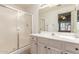 Well-lit bathroom featuring a vanity with ample storage and a shower with sliding glass doors at 14561 W Winding Trl, Surprise, AZ 85374