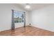 Bright bedroom features wood floors, neutral walls, ceiling fan, and large window for natural light at 14561 W Winding Trl, Surprise, AZ 85374