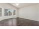 Bright bedroom featuring hardwood floors, a ceiling fan, and large bay windows at 14561 W Winding Trl, Surprise, AZ 85374