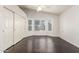Spacious bedroom with hardwood floors, a ceiling fan, bay window and closet for ample storage at 14561 W Winding Trl, Surprise, AZ 85374