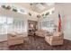 Cozy living room with large windows, comfortable seating, and tasteful decorations at 14561 W Winding Trl, Surprise, AZ 85374
