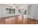 Bright living room featuring hardwood floors, large windows, a ceiling fan, and an elegant decorative alcove at 14561 W Winding Trl, Surprise, AZ 85374