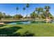 Beautiful pond on the golf course lined with palm trees on a bright sunny day at 14561 W Winding Trl, Surprise, AZ 85374