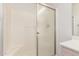 Shower featuring glass doors, shower bar, bright lighting and white walls at 14561 W Winding Trl, Surprise, AZ 85374