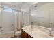 Bright bathroom with a double vanity, shower over tub and tile floors at 14922 N 172Nd Dr, Surprise, AZ 85388