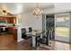 Dining area with a modern table and chairs, chandelier, and sliding glass doors to the patio at 14922 N 172Nd Dr, Surprise, AZ 85388