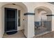 Inviting front porch with decorative arches and seating area, leading to the entry door at 14922 N 172Nd Dr, Surprise, AZ 85388