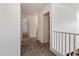 Upstairs hallway with carpet and white walls, featuring open doorways and natural light at 14922 N 172Nd Dr, Surprise, AZ 85388