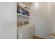 Functional laundry room with modern washer and dryer set and shelving at 14922 N 172Nd Dr, Surprise, AZ 85388