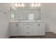 Bathroom featuring a double vanity with white cabinets and a large mirror at 1577 N Pueblo Dr, Apache Junction, AZ 85120