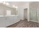Bright bathroom with double vanity, wooden tile floors, and glass-enclosed shower at 1577 N Pueblo Dr, Apache Junction, AZ 85120