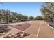 Community basketball court surrounded by mature landscaping and park benches at 1710 S Parkcrest St, Gilbert, AZ 85295